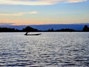 a person in a boat on a large body of water